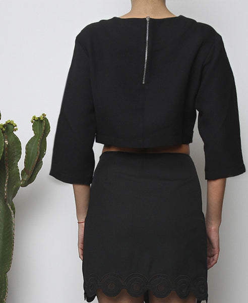 Bella London Black cropped top with boxy fit, front silver buckle fastening and ¾ sleeves. Close up back photo.