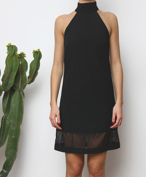 Bella London Black high neck shift dress with organza hem panel. Close up front photo.