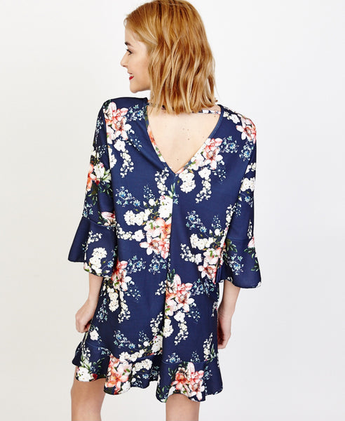 Bella London Willa Navy Floral Bell Sleeve Shift Dress With Ruffle Hem. Back View