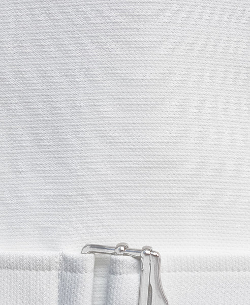 Bella London White boxy cropped top with buckle fastening and ¾ sleeves. Detail fabric photo.