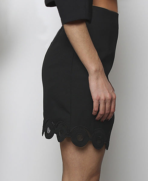 Bella London Black mini skirt with embroidered scalloped hem and organza inserts. Side photo.