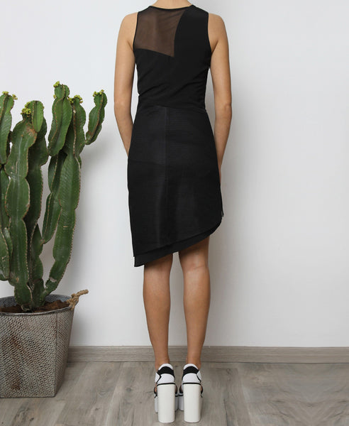 Bella London Panelled asymmetric black dress with mesh inserts. Back full length photo